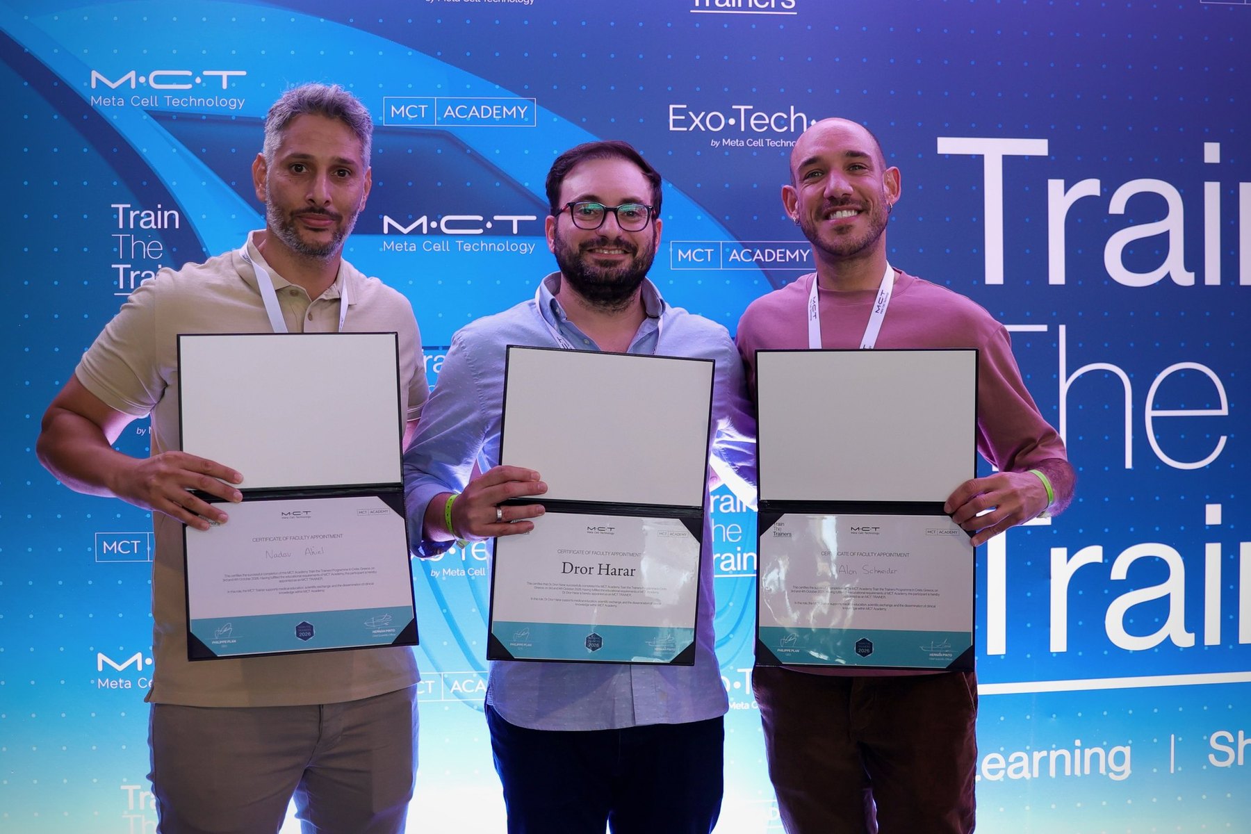 Physicians holding their MCT Trainer certificates during the Trainer Certification & Closing Remarks session